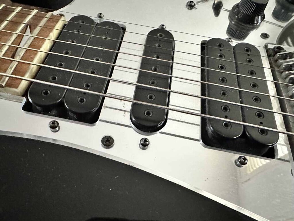 Closeup of Ibanez Universe seven string guitar with DiMarzio Blaze pickups.