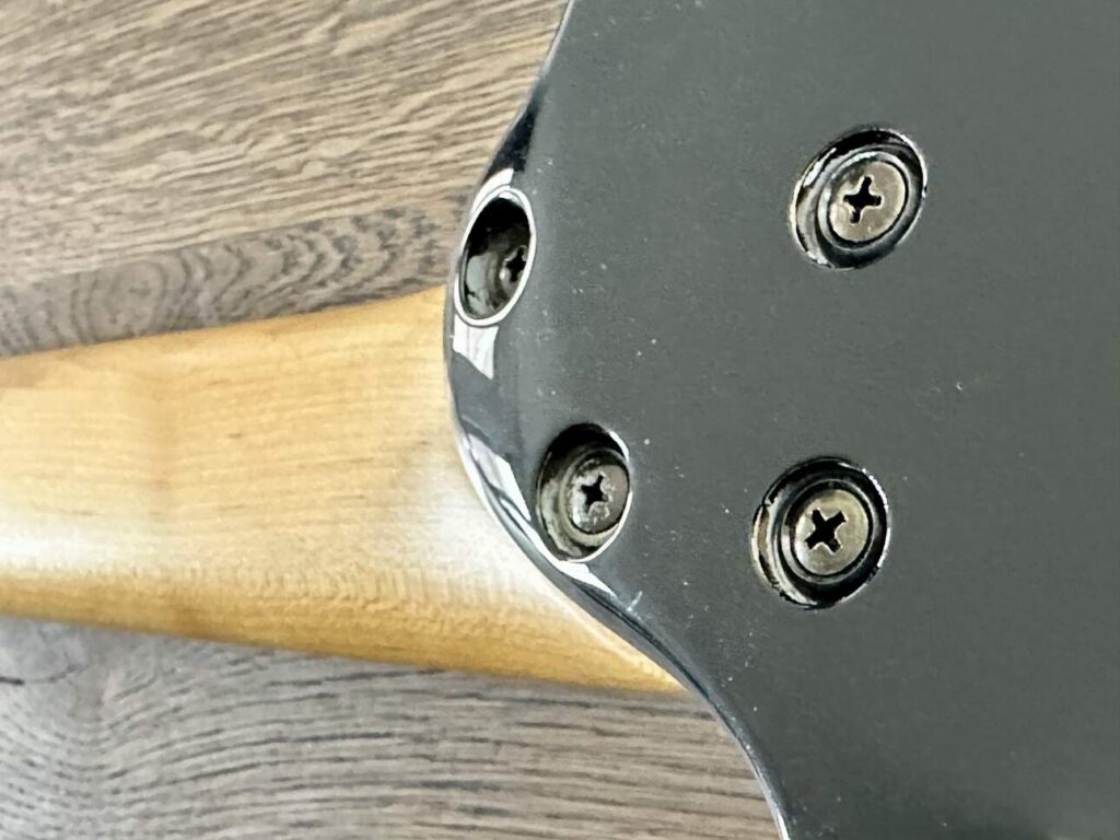 Closeup of the backside of a bolted on 24-fret neck on an Ibanez Universe 777BK 7-string electric guitar.