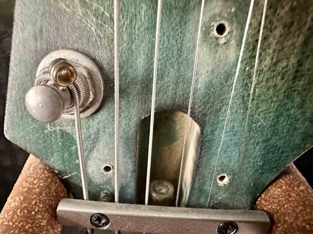 Closeup of a truss rod in the neck of an Ibanez Industrial Jem BSB electric guitar.