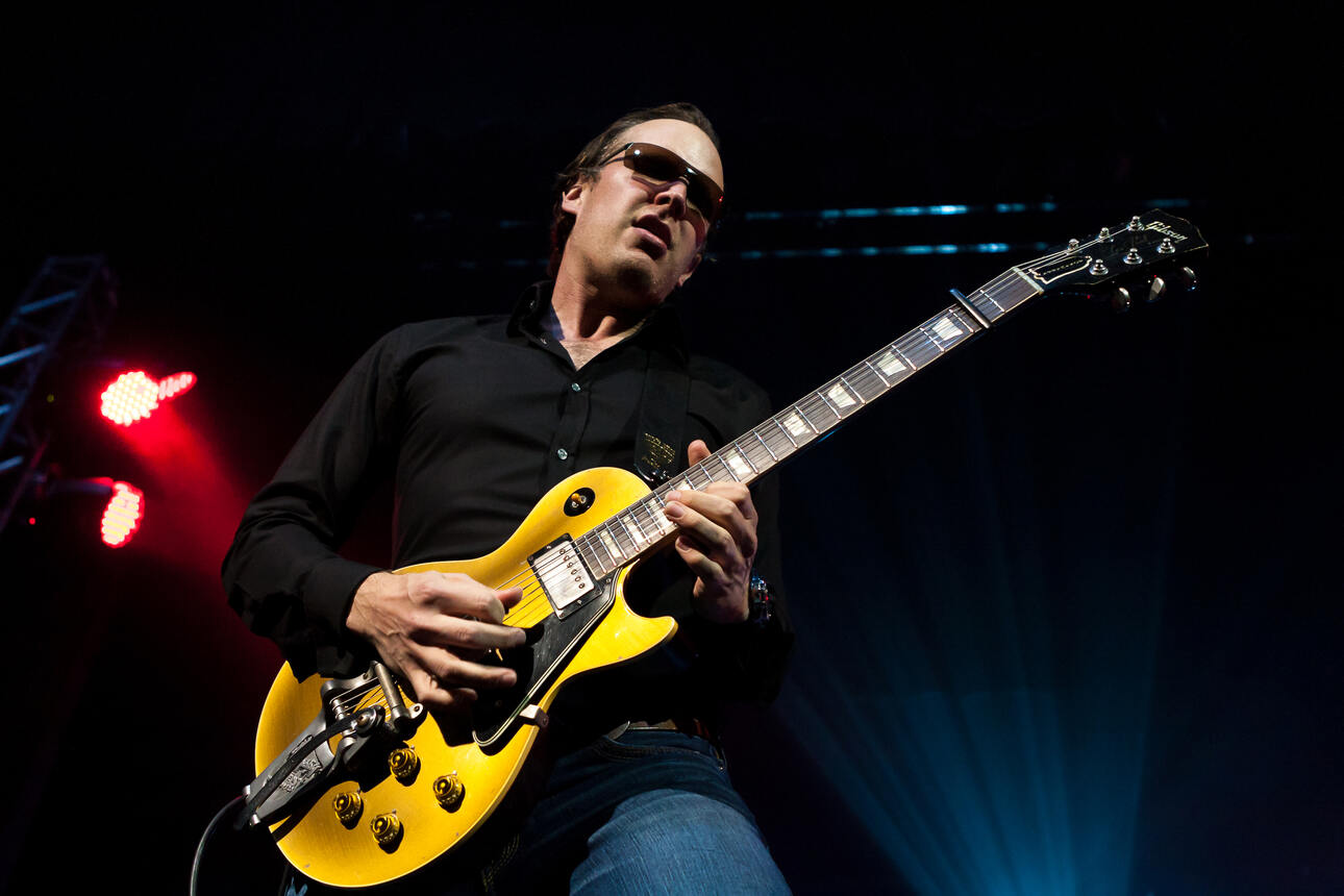 Blues guitarist Joe Bonamassa live on stage playing an ochre colored Gibson Les Paul.