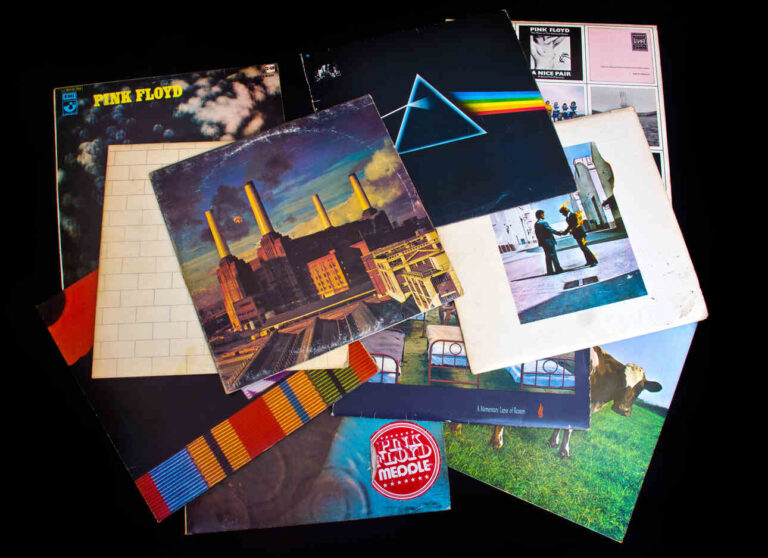A collection of long-player album covers of Pink Floyd laid out on a table.