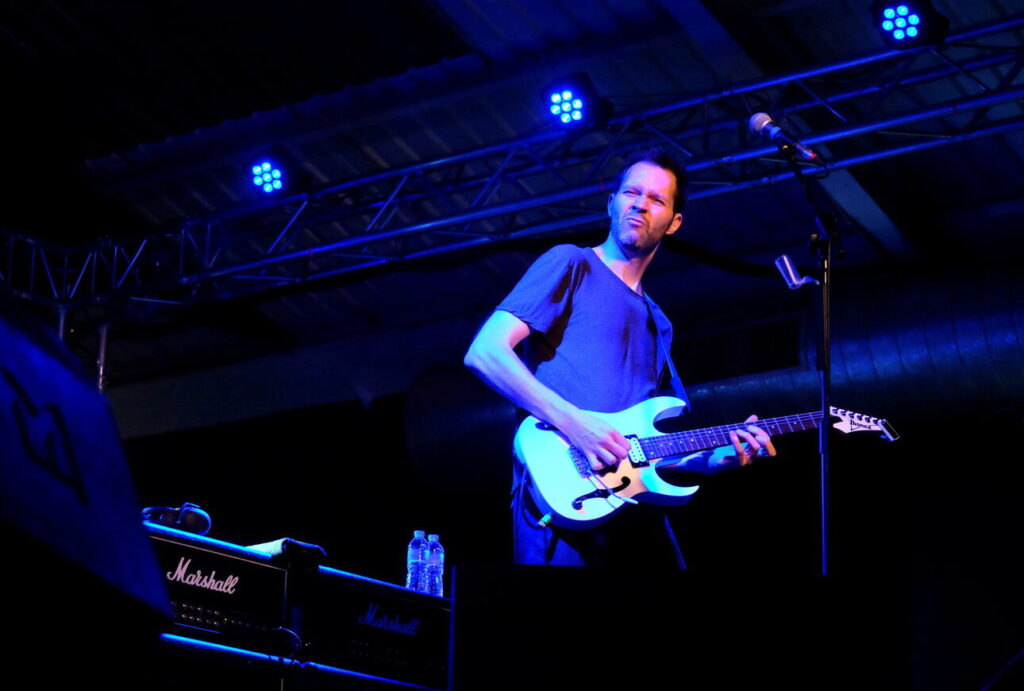 Guitarist Paul Gilbert of Mr. Big live on stage playing his white Ibanez Paul; Gilbert Signature Model.
