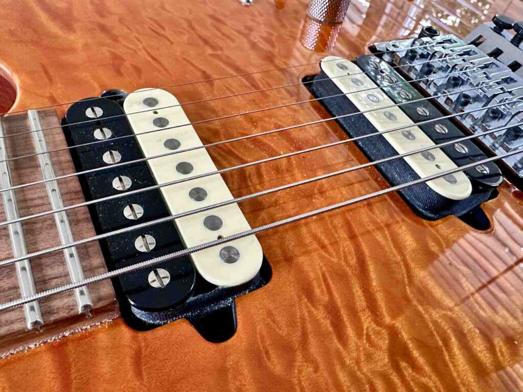 Two Suhr hot humbucker pickups on seven string guitar.