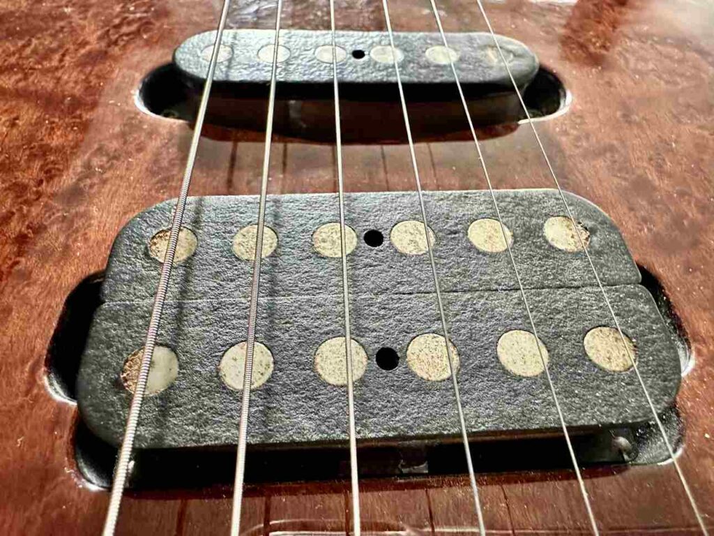 Closeup of a Tom Anderson single coil and humbucker pickup on a Schecter Hollywood Custom ltd. electric guitar.