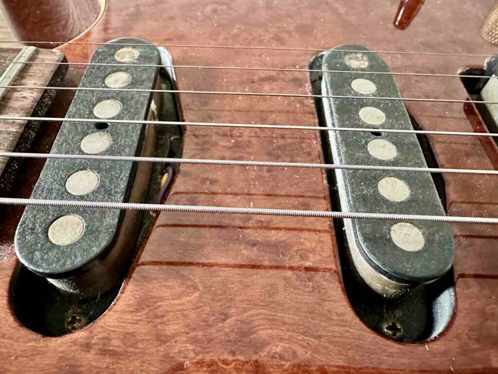 Closeup of two Tom Anderson single coil pickups on a Schecter Hollywood Custom ltd. electric guitar.