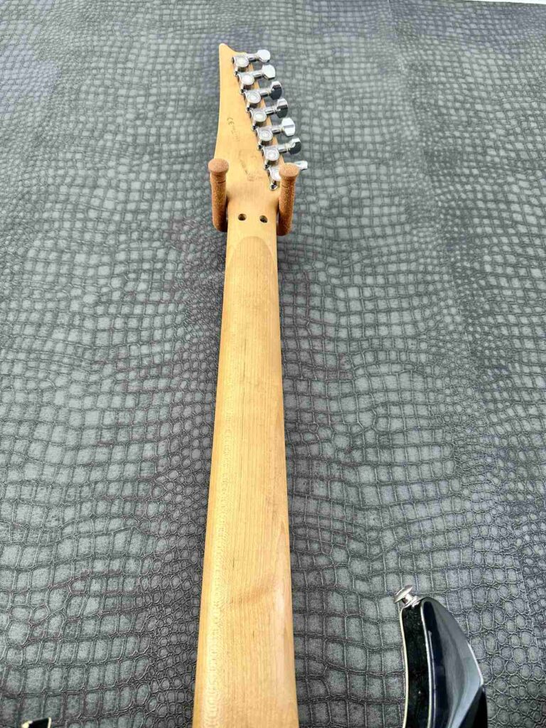 Backside of the guitar neck of an Ibanez Universe 777 BK.