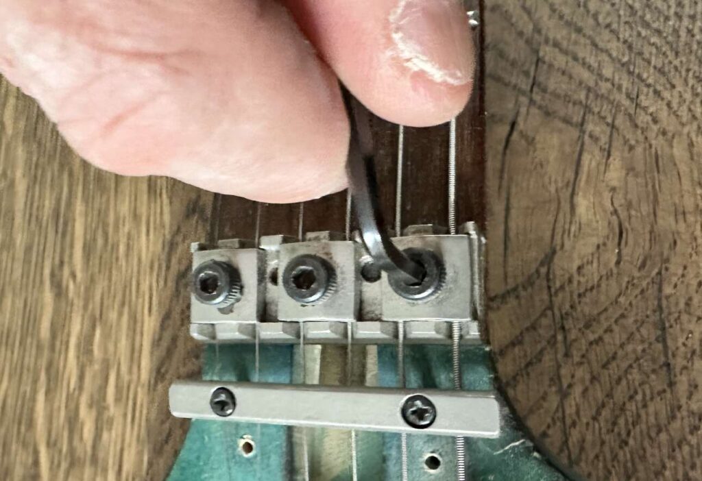 An Allen wrench in a silver locking nut on an Ibanez Jem BSB electric guitar.