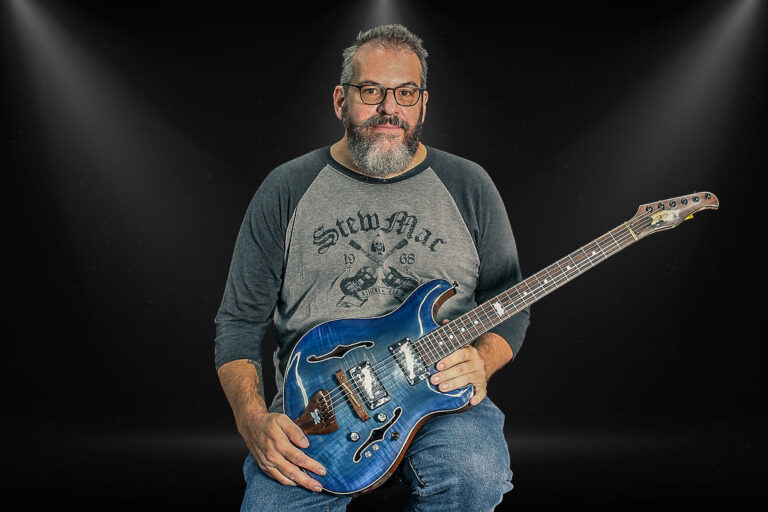 Bryant Haynie, CEO of RVA Guitars, holding his custom-built Starmaster model.